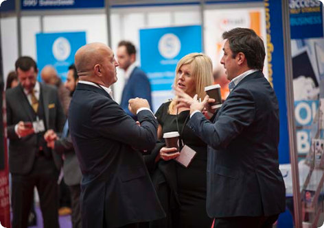 Business professionals networking at an event.